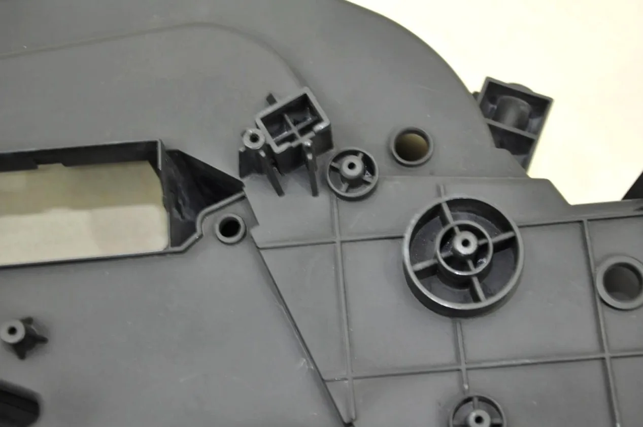 Structural housing with ribs and mounting bosses